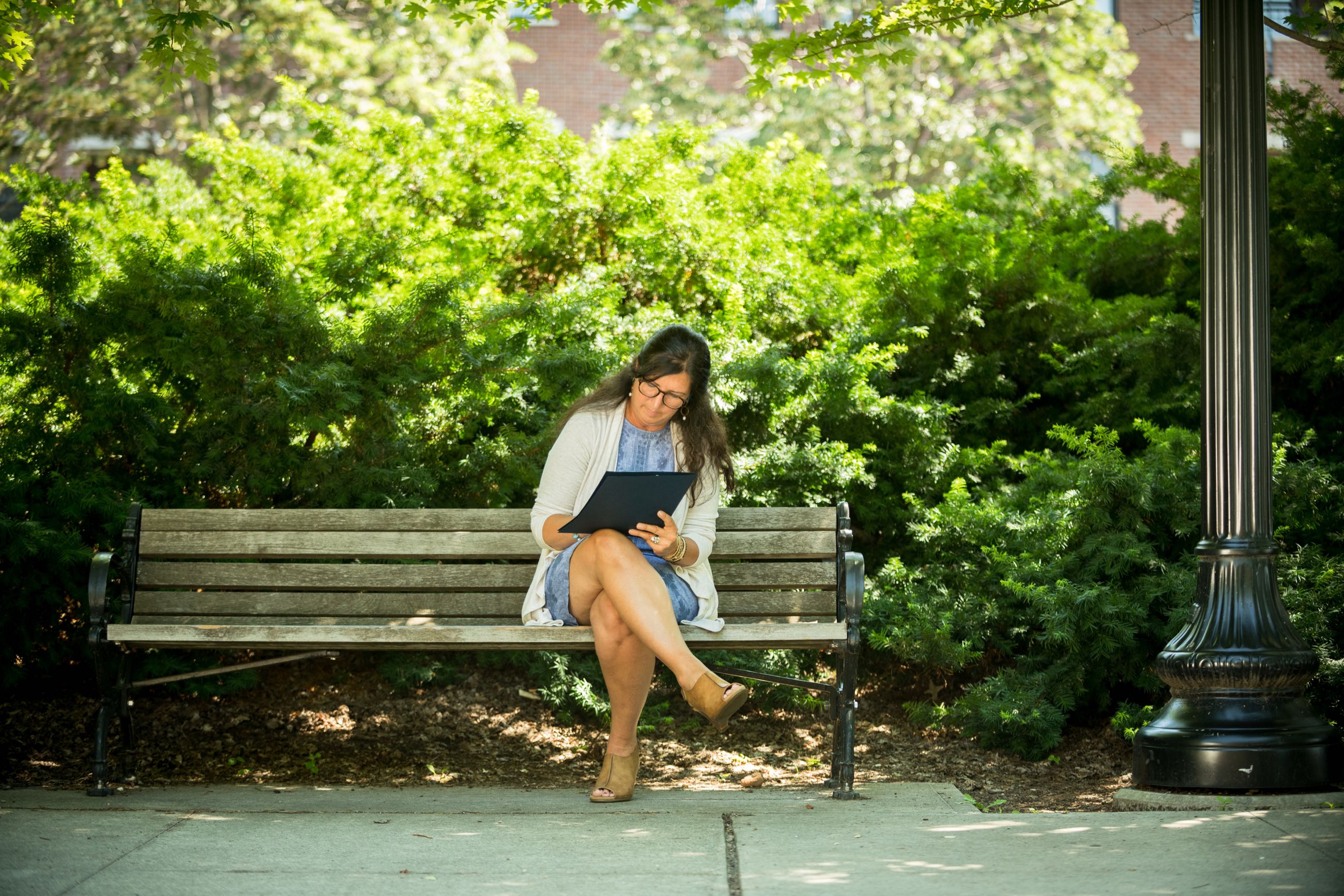 Student Working On Assignments On a Bench